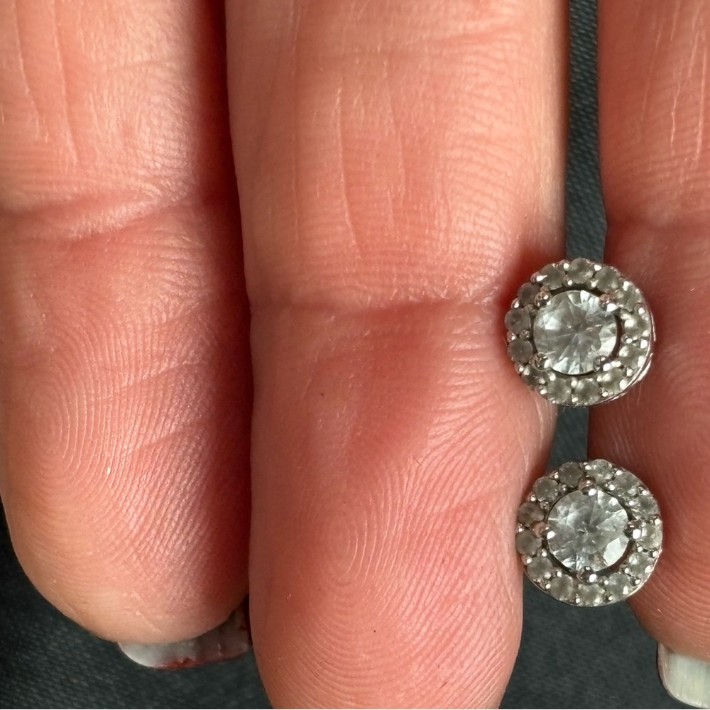 Sterling silver 925 studs with cubic zirconias.  
Hardly worn